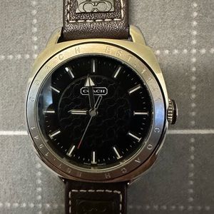 Coach Men’s round stainless watch. Dark brown leather buckle strap. Gently used